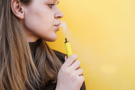 Lady Vaping on disposable vape